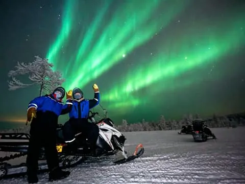 Hunting Northern Lights by Snowmobiles