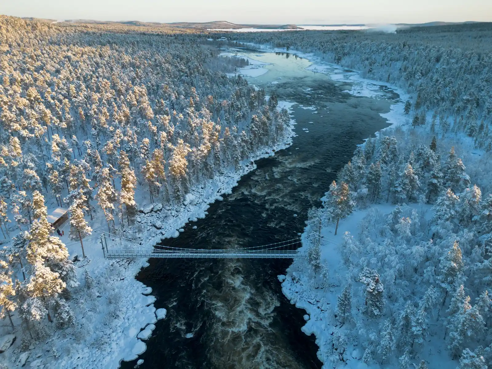 River through snow-covered forest near Inari